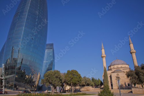 City view of the capital of Azerbaijan - Baku. Famous Flame Towers, mosque and funicular station.