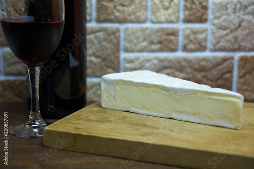 French cheese on a cutting board on a wooden table seen close up