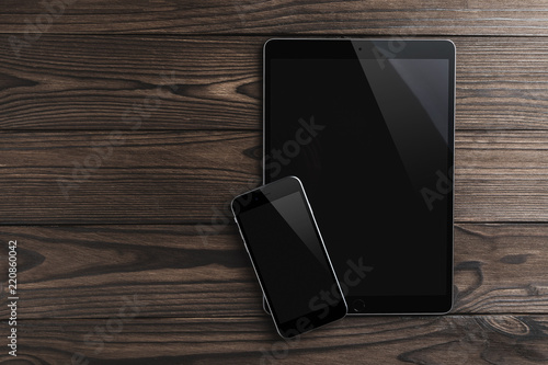 Wallpaper Mural Top view image of blank smart phone and tablet on old wooden table. Ready for adding text, flat lay Torontodigital.ca