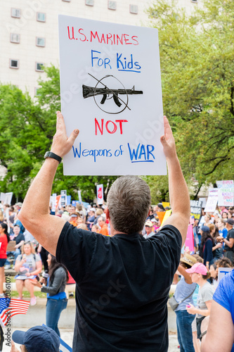 Ex Marine holds protest sign as Texas students and their families protest for gun control in March for Our Lives rally photo