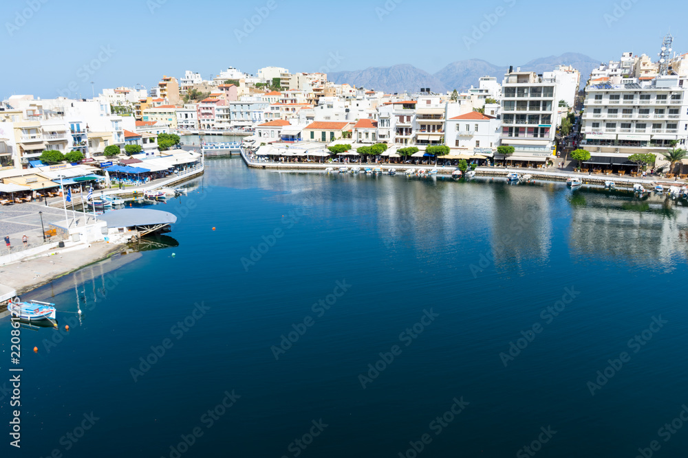 Obraz premium Agios Nikolaos. Crete. View to Lake Voulismeni. Boats at the pier.