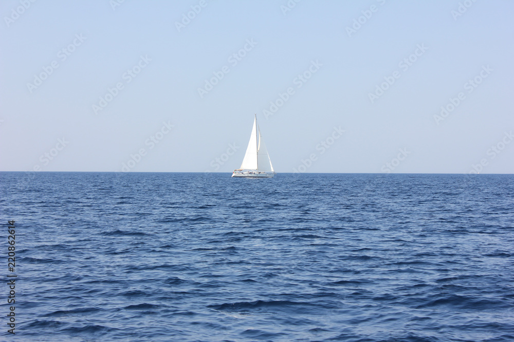 Sailboat In Blue Water