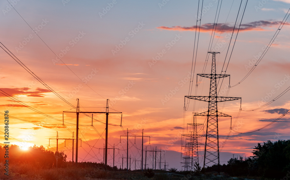 high-voltage power lines at sunset. electricity distribution station. high voltage electric transmission tower.