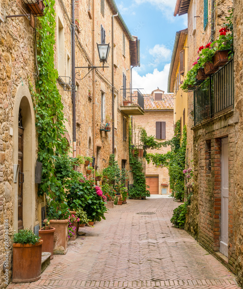 A narrow and picturesque street in Pienza, Tuscany, Italy.