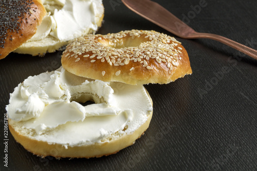 bagels with cream cheese. on black background.