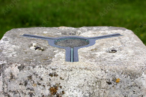 The brass plate used as a mounting point for a theodolite on top of a concrete British Ordnance Survey triangulation point, or Trig Point