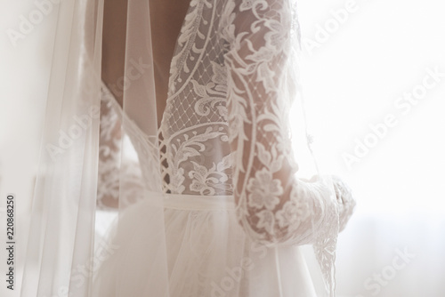Fototapete Beautiful Wedding dress and white bow isolated on white background