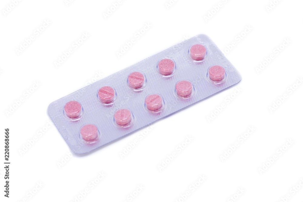 Pink pills in a package isolated on a white background Pink pills in a package isolated on a white background
