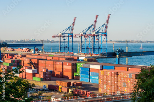  Logistics and transportation of a container cargo ship with a working crane at the shipyard, logistics export and transport industry.