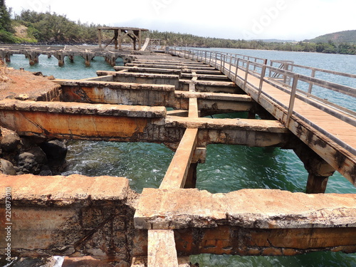 Remains of old pier at Ahukini Landing on the island of Kauai, HI photo