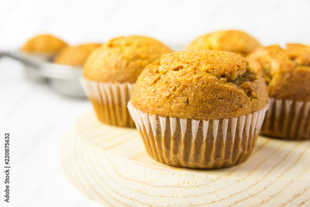 Freshly Baked Homemade Whole Wheat Bran Carrot Muffin on Wooden Board. Breakfast Morning Sunlight. Healthy Pastry Baking Concept. Minimalist Style Copy Space Freshly Baked Homemade Whole Wheat Bran Carrot Muffin on Wooden Board. Breakfast Morning Sunlight. Healthy Pastry Baking Concept. Minimalist Style Copy Space