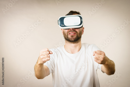 Adult man wearing vr goggles photo