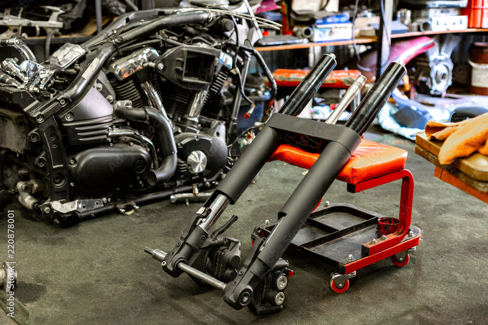 Professional auto repair service in the process of repairing a motorcycle. Professional auto repair service in the process of repairing a motorcycle.