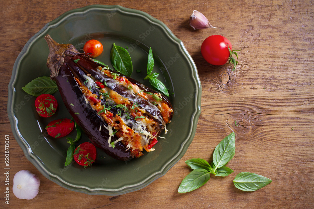 Baked eggplant, stuffed with meat, tomatoes, paprika, onion and cheese. Aubergine with meat and vegetables