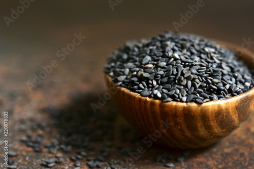 Black sesame seed in a wooden bowl.