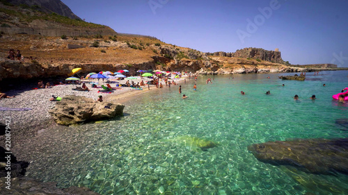 Beautiful pebble beach with transparent sea in Sicily, Italy.