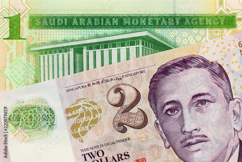 Canvas Print A close up image of a one Saudi Riyal note with a two Singapore dollar bank note