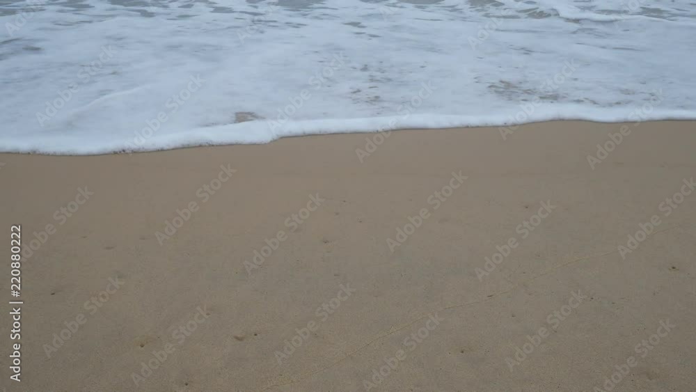 Beautiful sand beach with soft wave in sea water , cloudy rainy sky day Beautiful sand beach with soft wave in sea water , cloudy rainy sky day