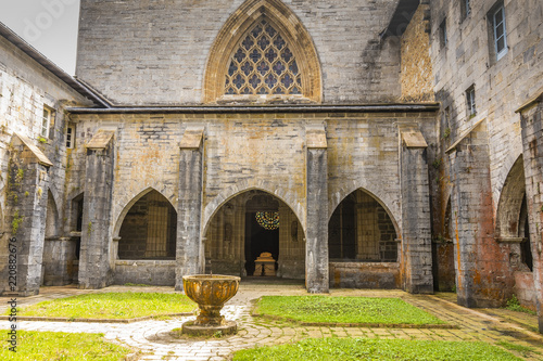 Gothic cloister of the thirteenth century and in the background the chapel of San Agustin in the city of Roncesvalles. Navarre Spain.