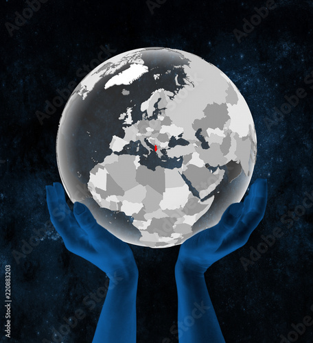 Fototapeta Naklejka Na Ścianę i Meble -  Albania on translucent globe in hands