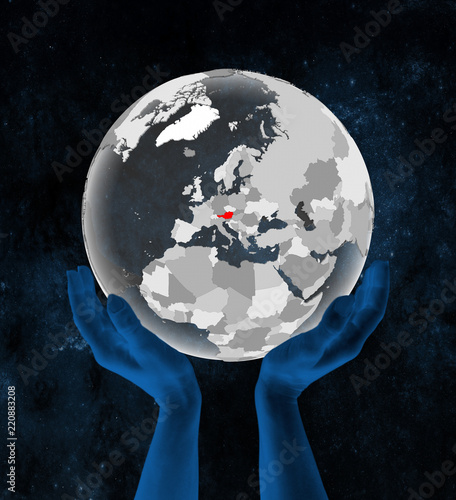 Fototapeta Naklejka Na Ścianę i Meble -  Austria on translucent globe in hands