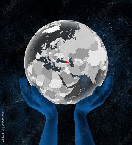 Fototapeta Naklejka Na Ścianę i Meble -  Georgia on translucent globe in hands