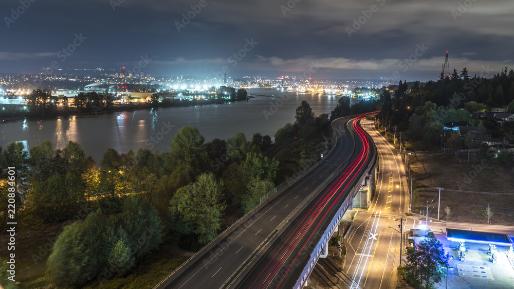 Long exposure at night from the Alex Fraser bridge above highway 17. Lights and glitters are seen in the frame. Surrey to Burnaby highway 91. Beautiful British Columbia, Canada.