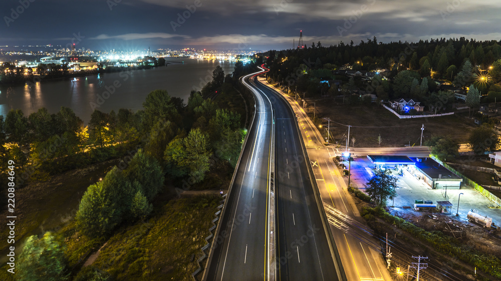 Long exposure at night from the Alex Fraser bridge above highway 17. Lights and glitters are seen in the frame. Surrey to Burnaby highway 91. Beautiful British Columbia, Canada.