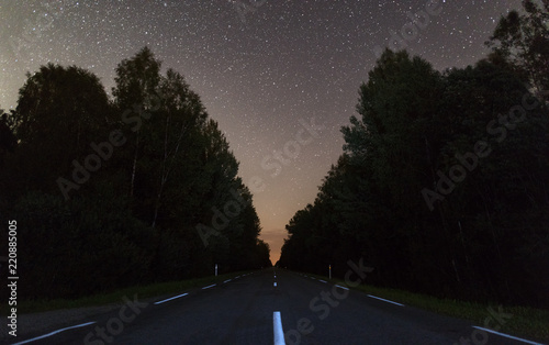 Clear night sky full of stars above the road.
