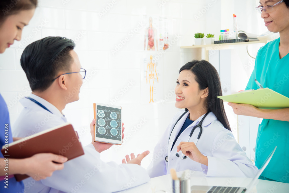 Group of doctors and nurses discuss and looking patient's x-ray result Group of doctors and nurses discuss and looking patient's x-ray result
