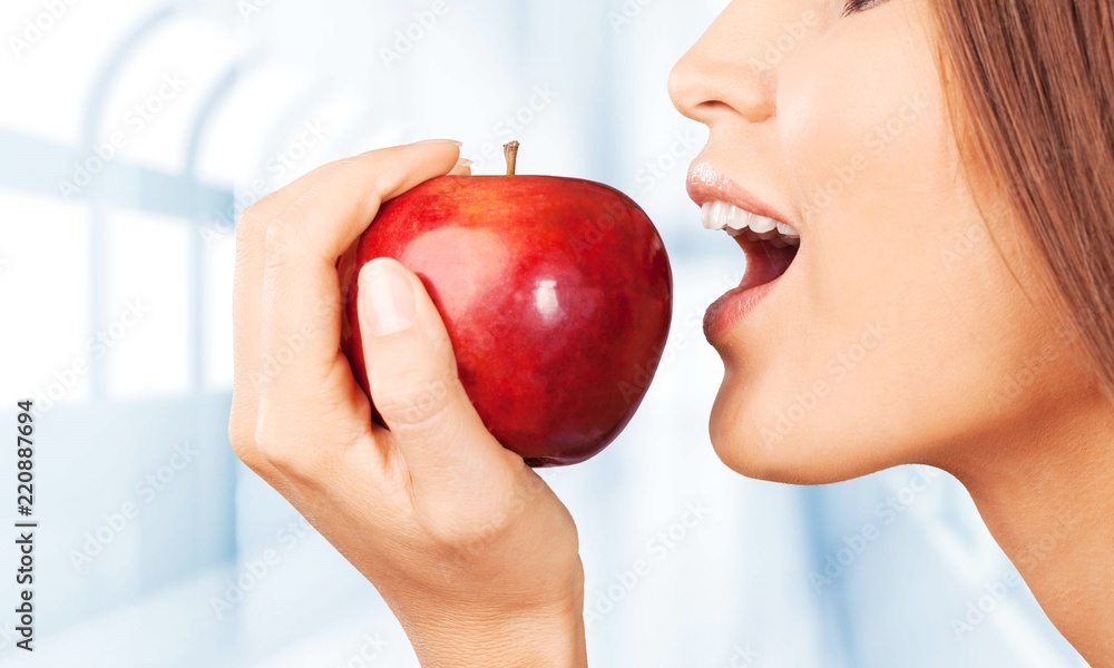 Young woman holding fresh apple on white background Young woman holding fresh apple on white background