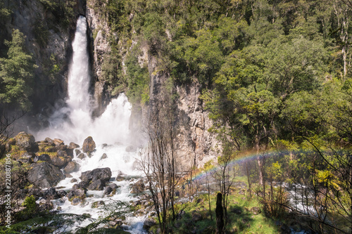 Tarawera falls with rainbow gushing out of fissures in the cliff, Rotorua, New Zealand photo