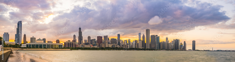 chicago,illinois,usa. 8-11-17: Chicago skyline at sunset with cloudy sky and reflection in water. chicago,illinois,usa. 8-11-17: Chicago skyline at sunset with cloudy sky and reflection in water.