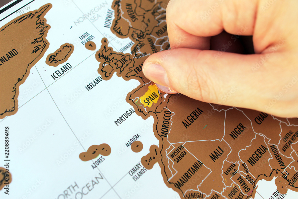 Fototapeta premium Man's hand scratching of visited places on a map. Europe travel. A travel destinations concept