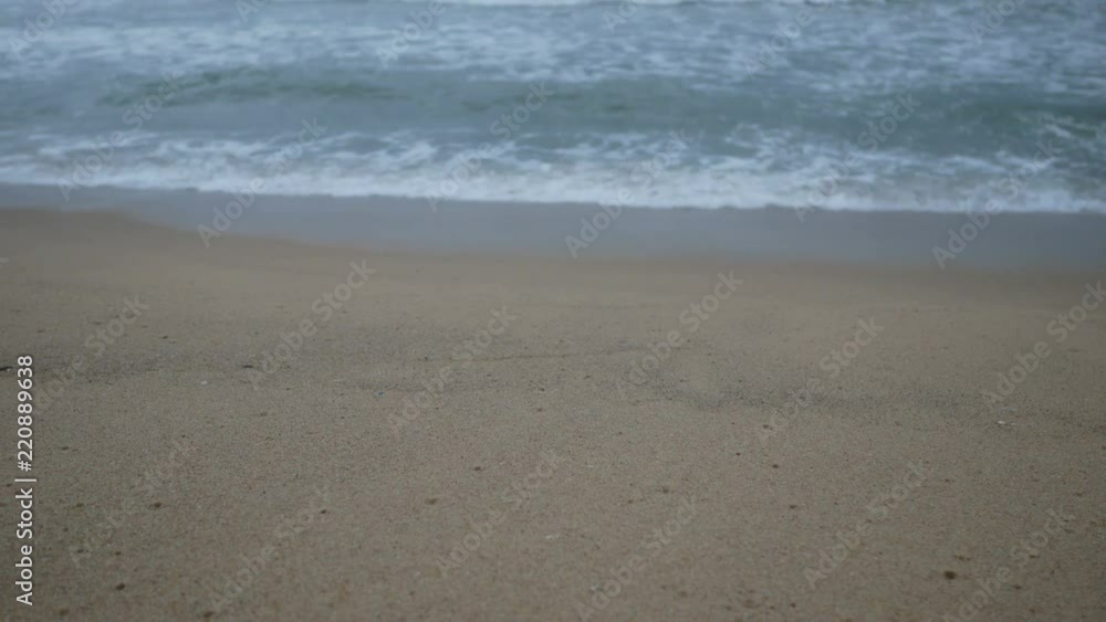 Beautiful sand beach with soft wave in sea water , cloudy rainy sky day Beautiful sand beach with soft wave in sea water , cloudy rainy sky day