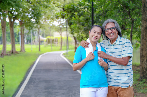 Senior asia couple have happiness and wellbeing life by exercise with freshness in the park, maintaining the health and mind of elderly family in retirement concept.