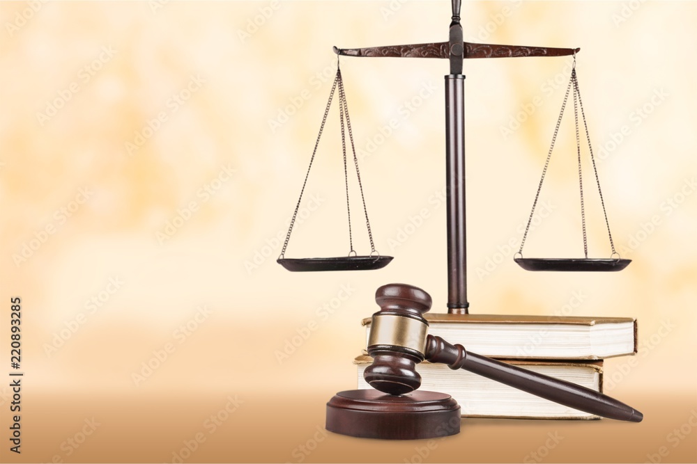 Justice Scales and books and gavel on wooden table Justice Scales and books and gavel on wooden table