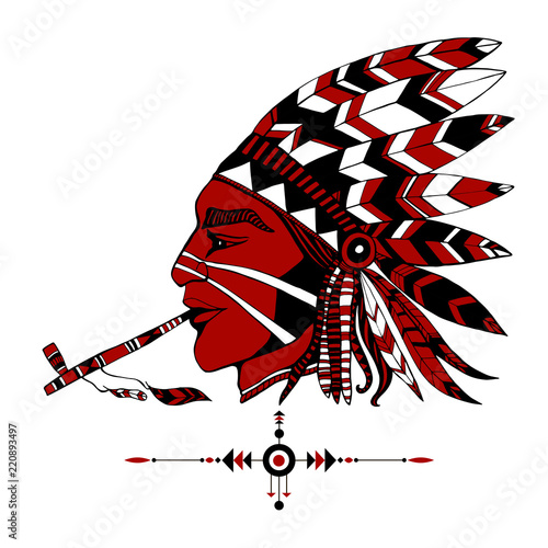Red-skinned Indian shaman in ethnic costum smokes a pipe of peace.