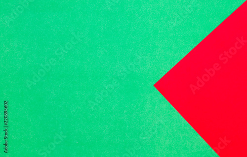 Green and red pastel papers geometric lay as background.