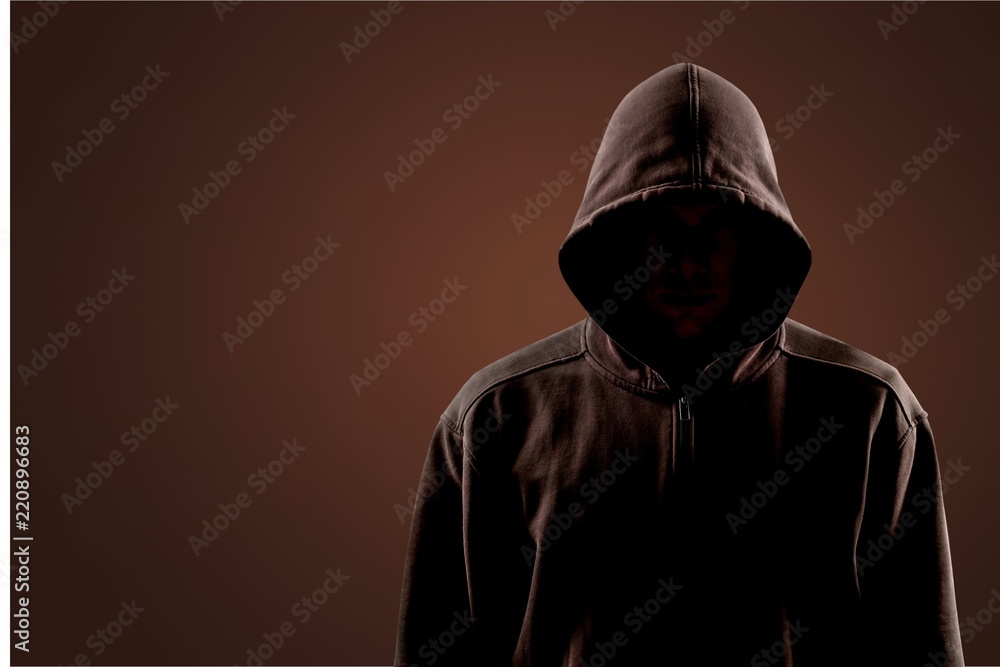Dark unrecognisable man in hoodie on background