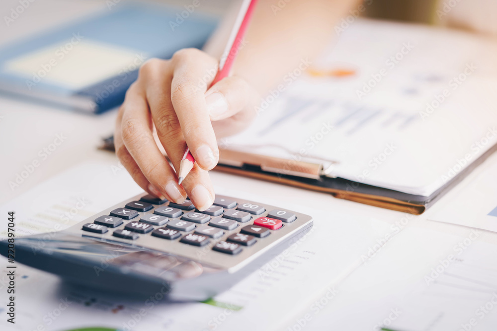 Close up of bookkeeper or financial inspector hands making report, calculating or checking balance.Investment, economy, saving money or insurance concept Close up of bookkeeper or financial inspector hands making report, calculating or checking balance.Investment, economy, saving money or insurance concept