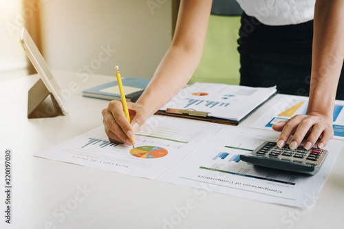 Businesswoman using tablet computer and calculator for calculating financial documents. Accounting,Finances and economy concept.