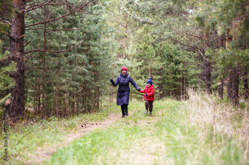 Granny and little grandson run on forest
