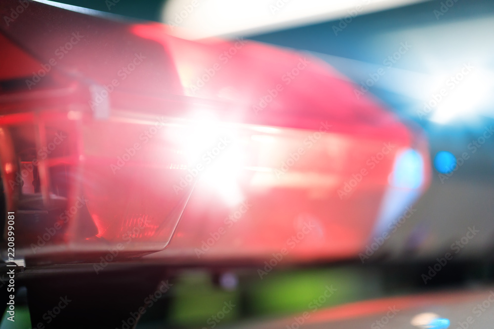 Red flashes on the car of the emergency vehicle at night. Police patrol car of the specialized unity in the night time. Police lights during traffic surveillance on the city road. Red flashes on the car of the emergency vehicle at night. Police patrol car of the specialized unity in the night time. Police lights during traffic surveillance on the city road.
