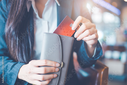 Women's hand Using a credit card, she pulled the card out of her wallet.