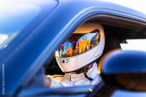A Helmeted Driver At The Wheel Of His Race Car © SIX60SIX