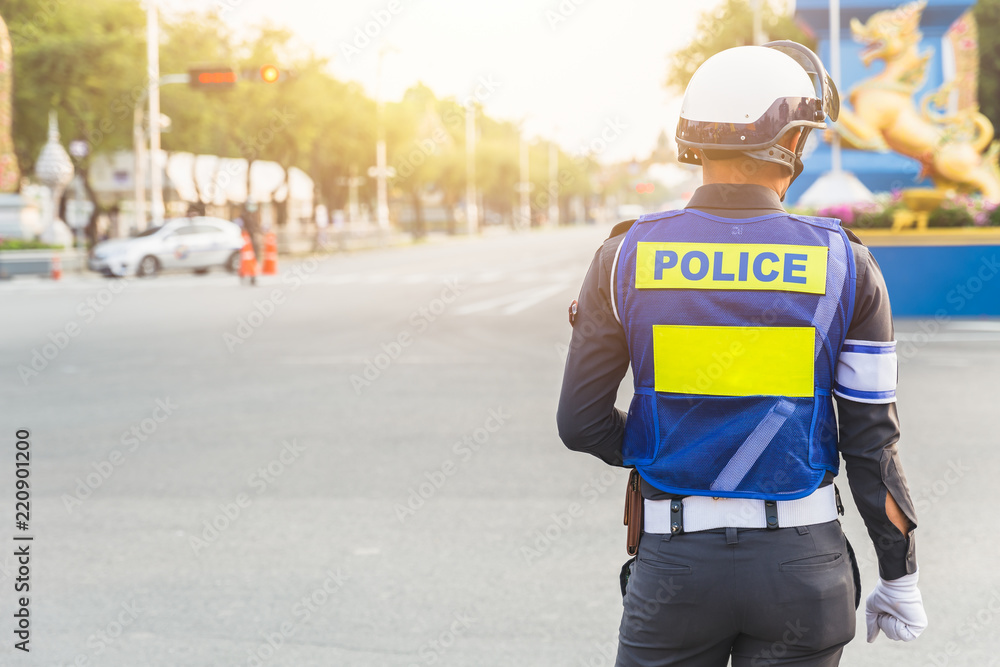 Police officer on traffic control security duty in Thailand. Police officer on traffic control security duty in Thailand.