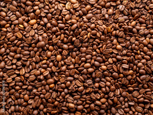 Close-up roasted coffee beans background, top view, copy space