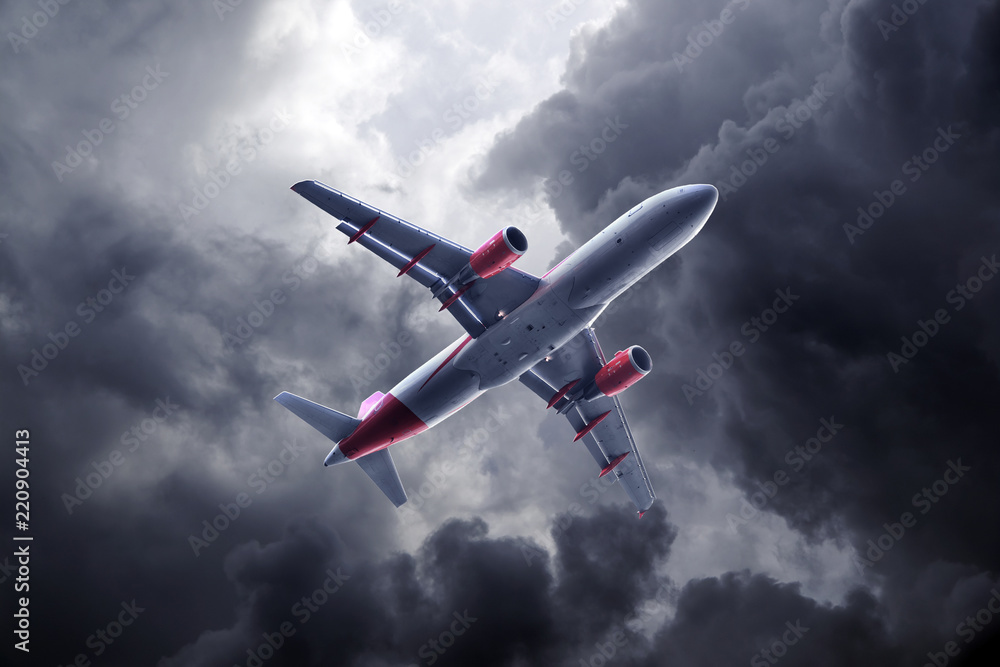 Fototapeta premium Passenger airplane flying on stormy sky with dark clouds and lightnings.