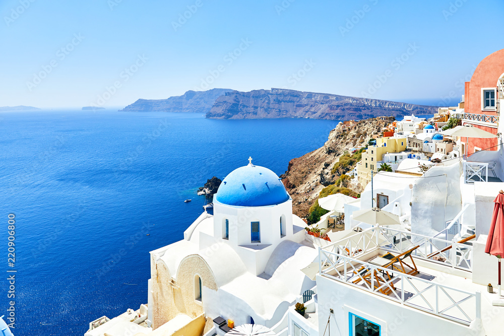 white houses with blue roofs on Santorini
